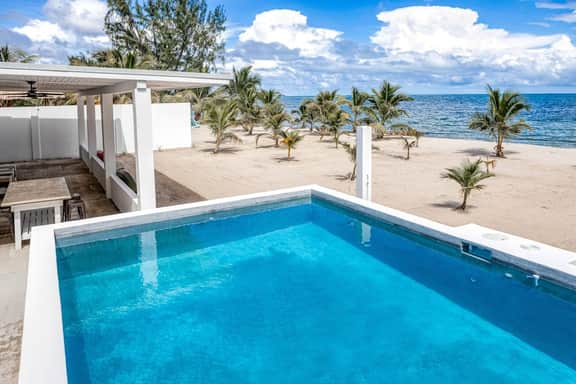 Luxurious beachfront home with private pool, rooftop grill, and sea views