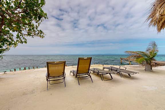 Overwater cabin with oceanfront deck, island kitchen & sea breeze views