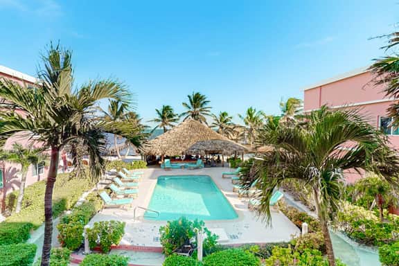Ocean-view studio with pool, WiFi & partial AC - steps from the beach