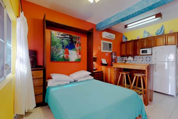 Ocean-view studio with pool, WiFi & partial AC - steps from the beach