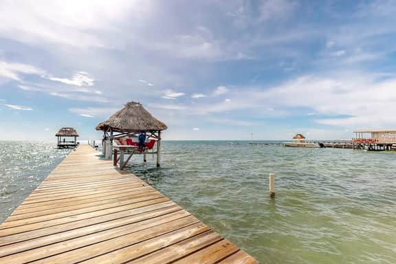 Beachfront condo w Caribbean Sea view, shared pool & dock, partial AC & WiFi