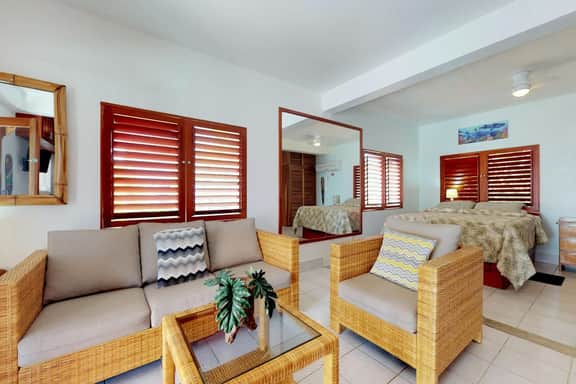 Beachfront condo w Caribbean Sea view, shared pool & dock, partial AC & WiFi
