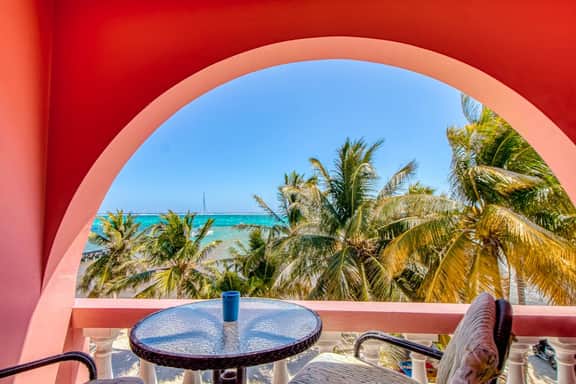 Beachfront condo with beach access, dock, pool, balcony, & ocean views