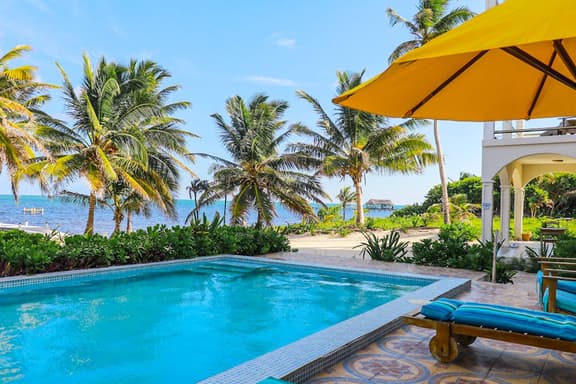 Beachfront condo with ocean views, WiFi, partial AC & shared pool, dock, kayaks