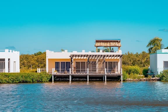 Cozy Waterfront Villa Home w Shared Pool, Water Views, WiFi, & AC - Walk to the Beach