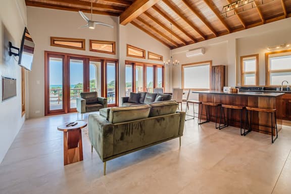 Tropical retreat villa with a pool, dock, bikes, canoes, balconies, and 360 views