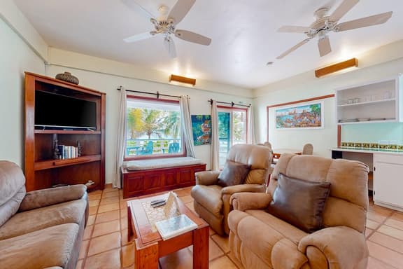 Colorful oceanfront condo with shared pool, WiFi, ocean view, and central AC