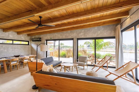 Stylish waterfront villa with pool, lush views & floor-to-ceiling windows